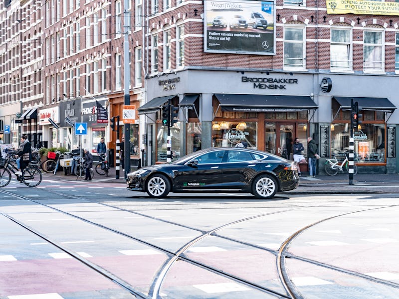 A Tesla Model S is seen turning at an intersection.