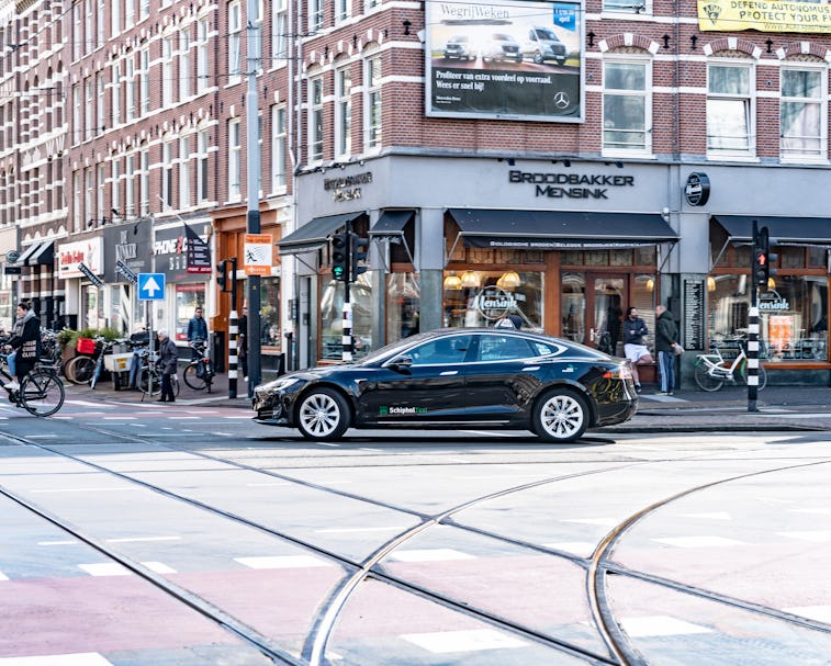 A Tesla Model S is seen turning at an intersection.