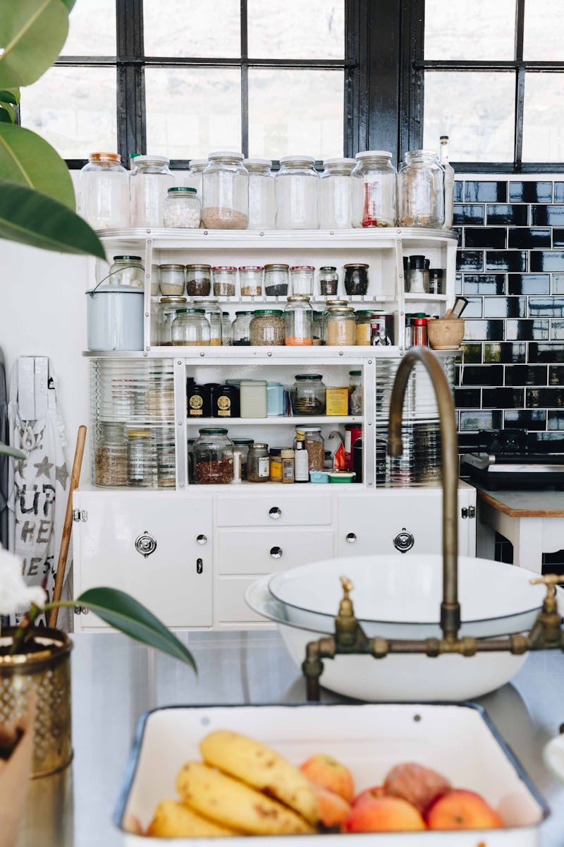 An organized shelf in a kitchen with fruit in the foreground. Therapists explain why people can't st...