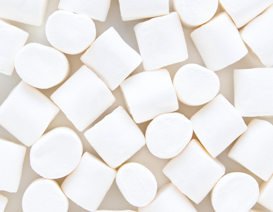 White marshmallows on a gray backdrop. A doctor explains that marshmallows are not a sore throat rem...