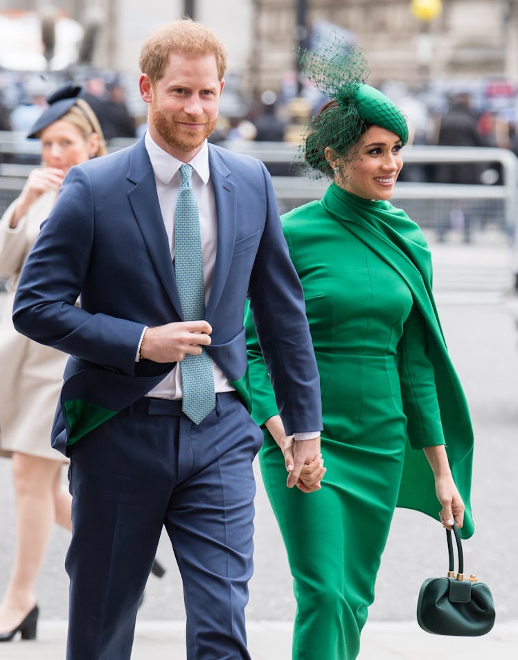 Prince Harry and Meghan Markle hold hands.