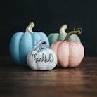A group of pastel pumpkins sit on the wood floor, for which you need captions for pastel pumpkins to...