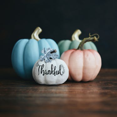 A group of pastel pumpkins sit on the wood floor, for which you need captions for pastel pumpkins to...