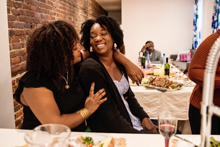 two women hugging at thanksgiving, hostess