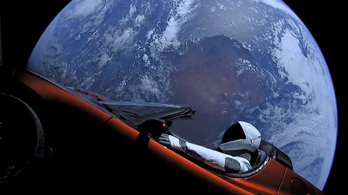Tesla's Starman dummy is seen in view from space in the red Roadster.
