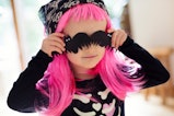 a toddler girl in a pink wig