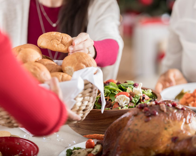 bread rolls being passed at thanksgiving table