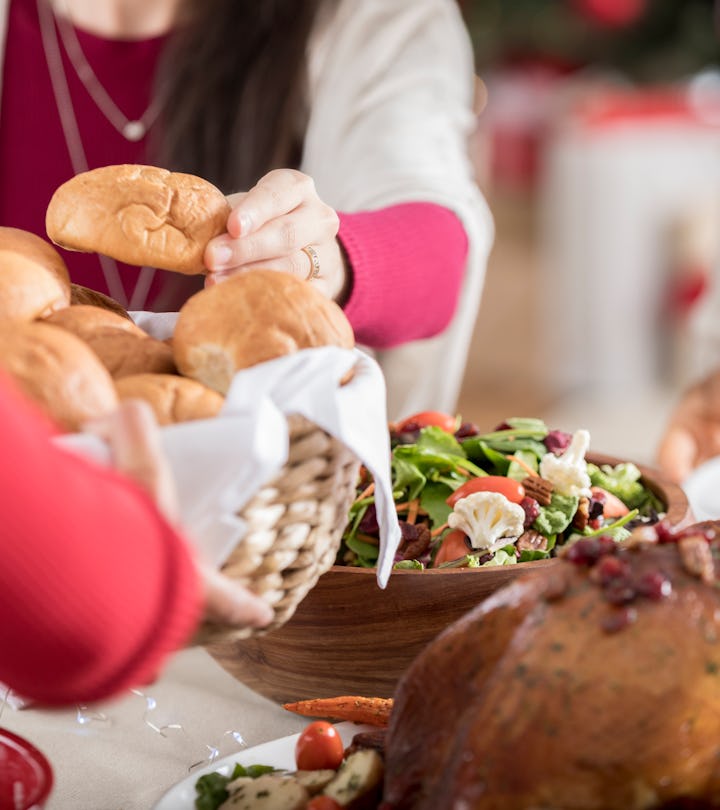 bread rolls being passed at thanksgiving table