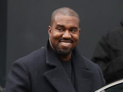 Kanye West flashes a smile.