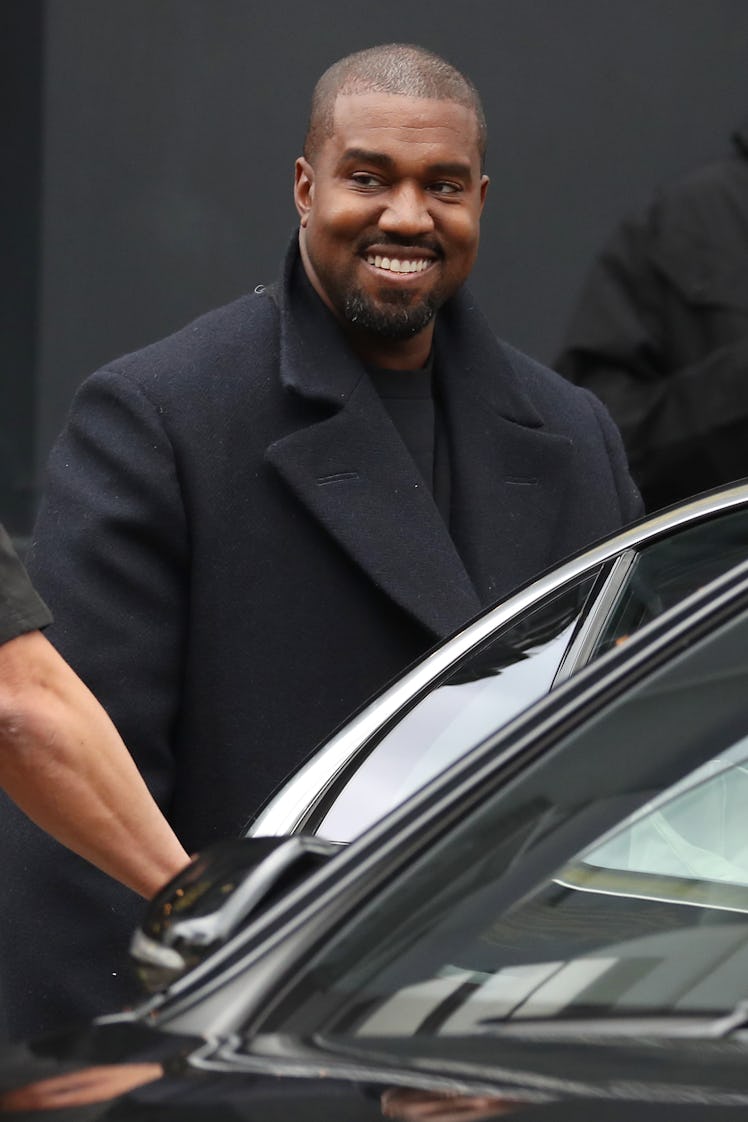 Kanye West flashes a smile.