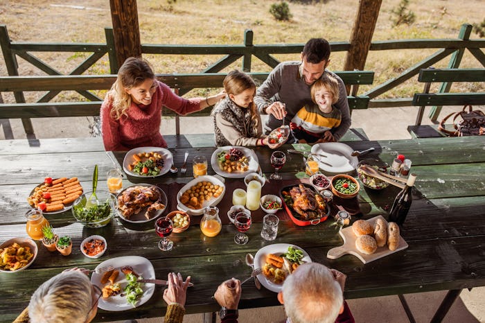 family eating thanksgiving dinner outside
