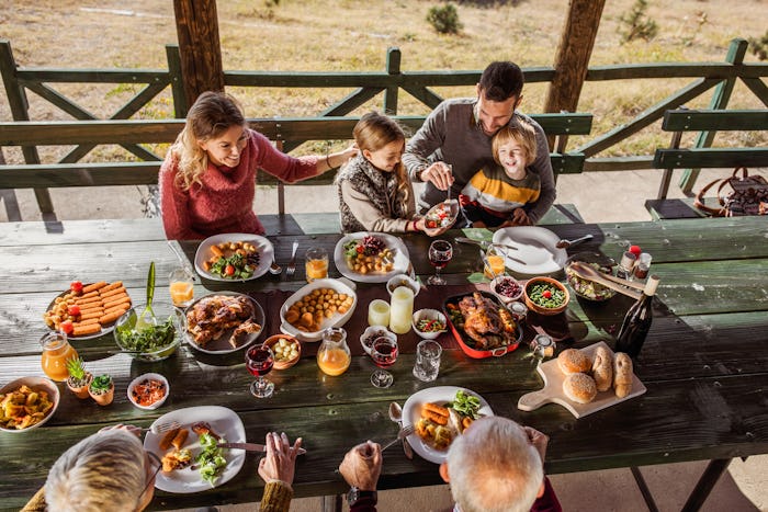 family eating thanksgiving dinner outside