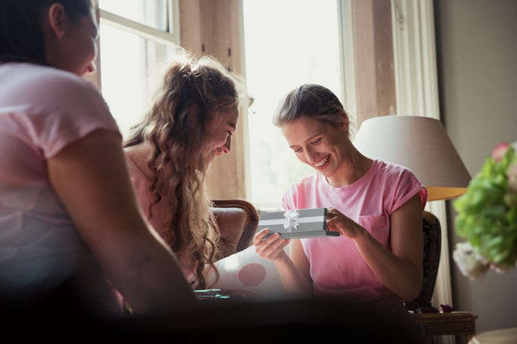 A group of bridesmaids receiving gifts.