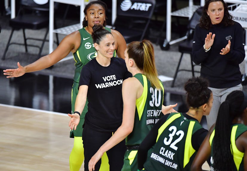 Sue Bird, former basketball player, wearing a "Vote Warnock" t-shirt during a game in the WNBA