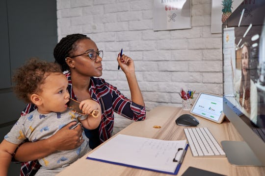 mom working from home with son on lap