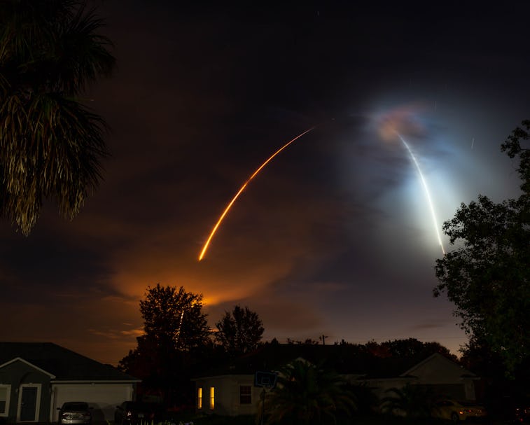 SpaceX rocket launching into space over a night sky.