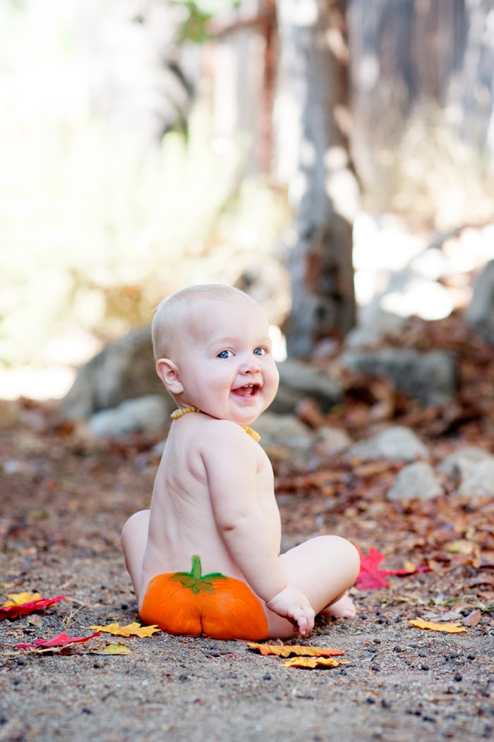 baby with a pumpkin painted on its butt
