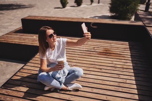 Woman looks at her most liked Instagram post.