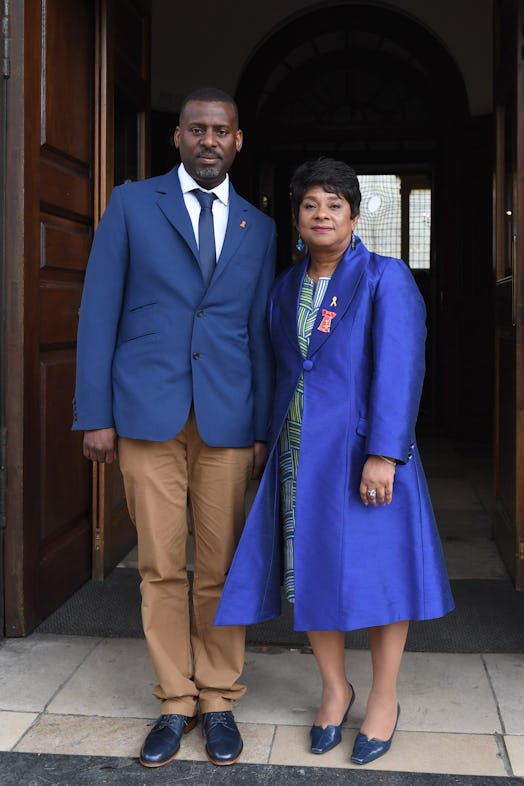 stuart and doreen lawrence wearing a blue and tan suit and blue coat respectively