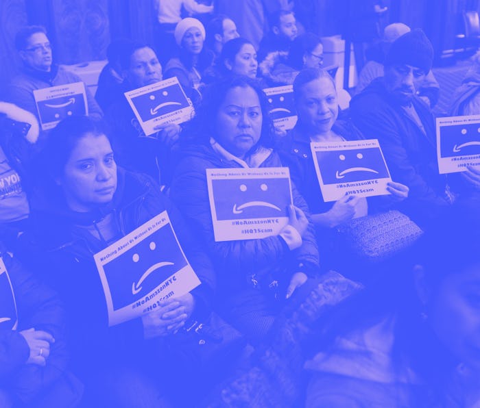 Protesters carrying signs against Amazon.