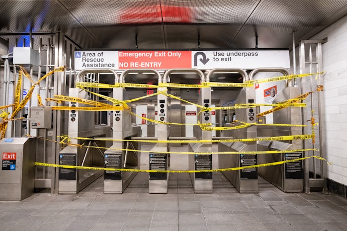 The entrance to the NYC subway system covered in caution tape.