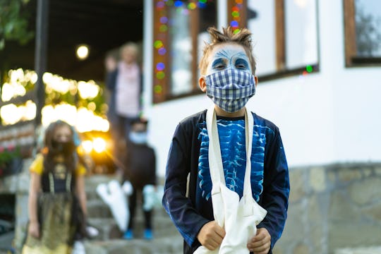 kid with face mask on halloween