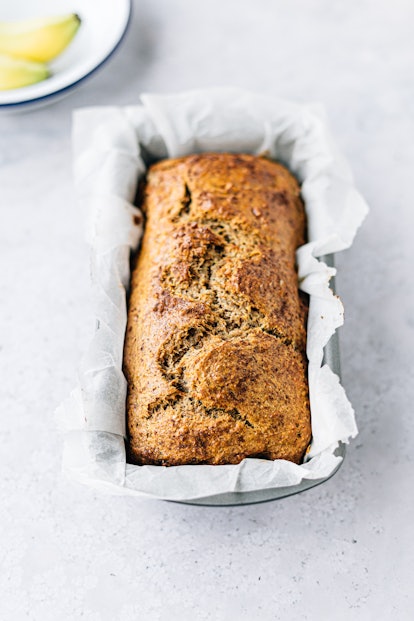 A load of golden brown banana bread in a greaseproof-lined metal tin