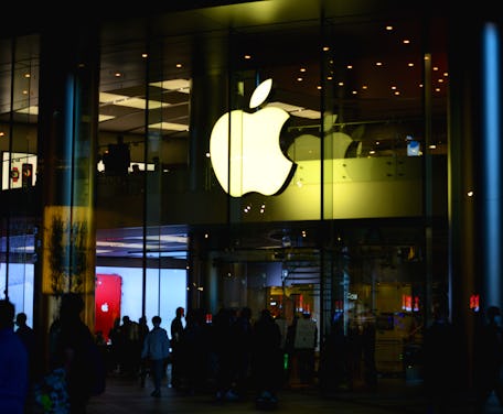 The Apple logo appears inside a retail store.