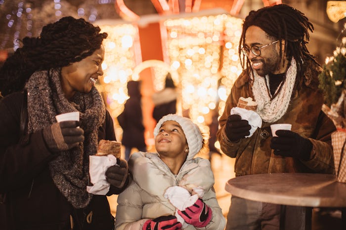 mom with little girl and partner drinking coffee