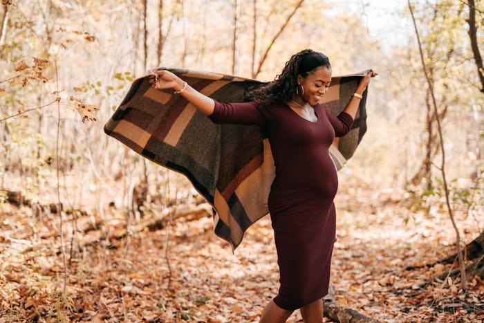 pregnant woman outside in the fall