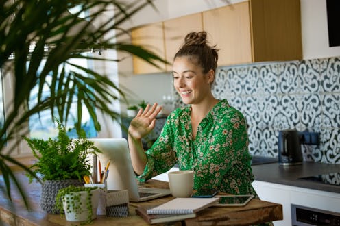 A woman Zooms in front of her kitchen. Going home for the holidays may be tricky this year.