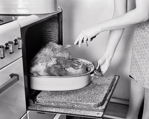 A woman pricks a thanksgiving turkey in the oven. Experts reveal strategies for dealing with politic...