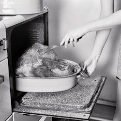 A woman pricks a thanksgiving turkey in the oven. Experts reveal strategies for dealing with politic...