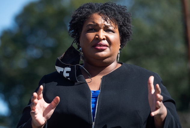Stacey Abrams giving a speech in a blue shirt and a black blazer
