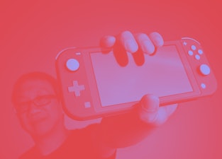 Nintendo Switch in a man's hand.