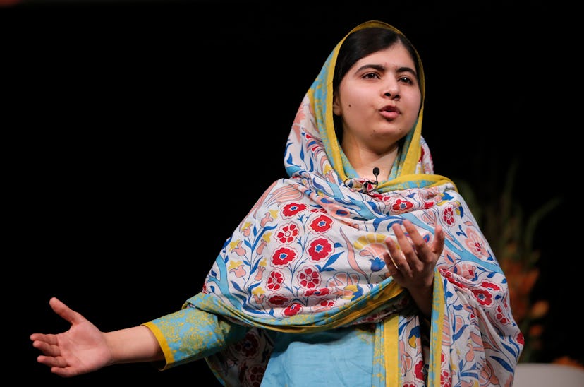 Malala Yousafzai giving a speech in a floral headscarf and dress