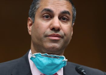 FCC Chairman Ajit Pai is pictured with an N95 mask below his chin.