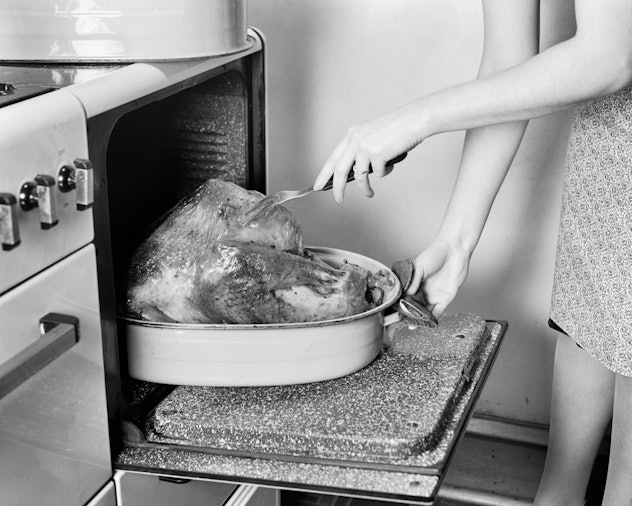 Woman checking her turkey for doneness.