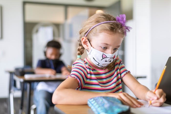 little girl in mask at school