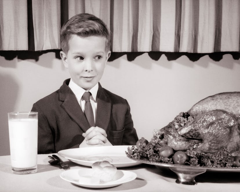 Vintage photo of a child staring down a turkey.