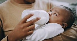 Father feeding his baby with a milk bottle