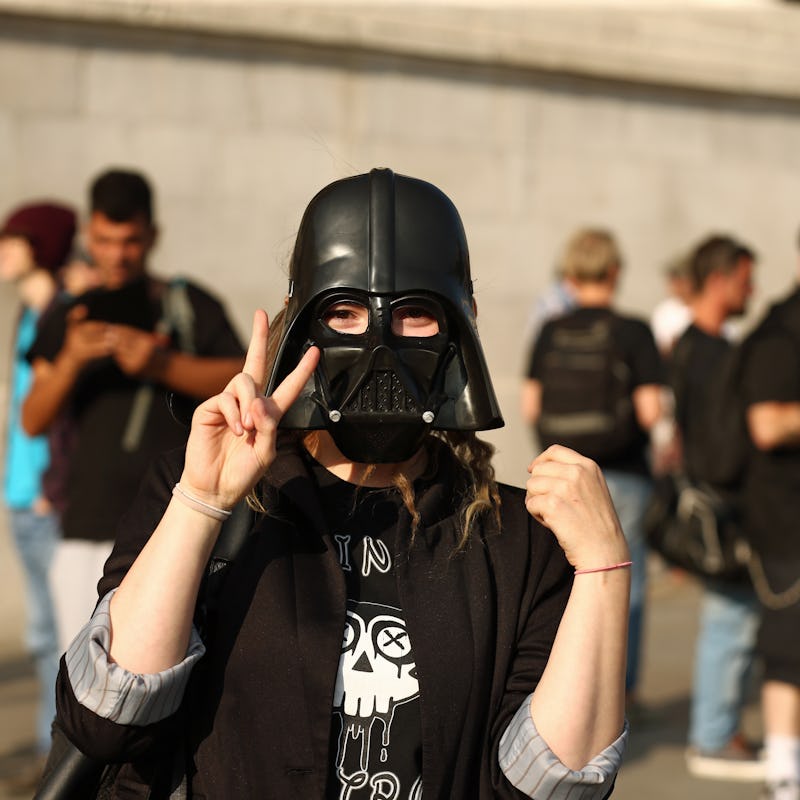 A demonstater in a Darth Vader mask star wars political protest 