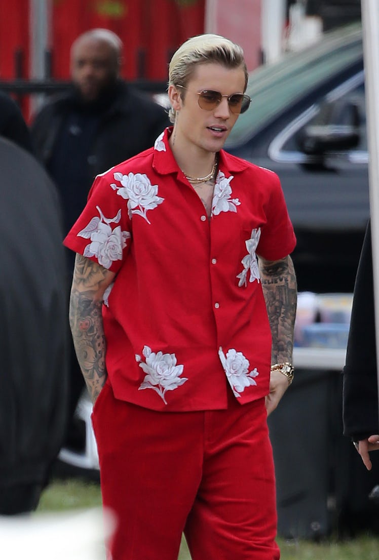 Justin Bieber steps out in a red floral tee and matching pants.