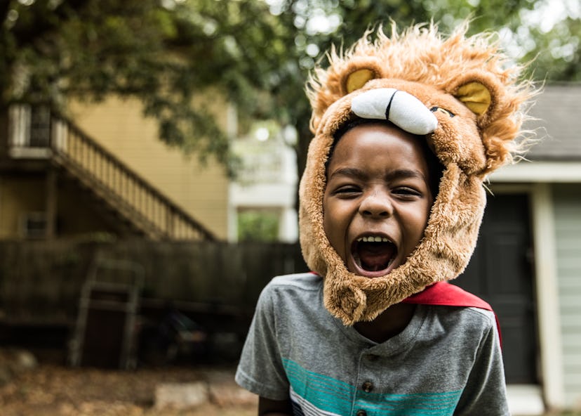 This child is playing with a lion costume.