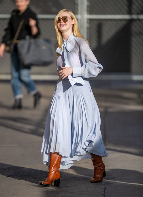 Blonde lady walking in a light blue dress
