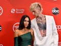 Megan Fox in a green dress and Machine Gun Kelly in a white suit on the AMAs red carpet event