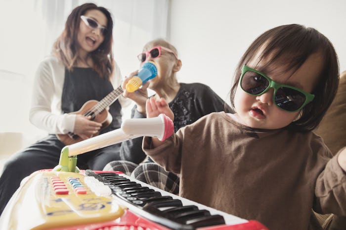 baby and family pretending to play rock music in article about names inspired by  songs