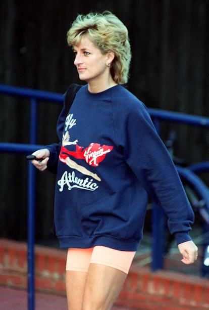 Princess Diana in a sweatshirt and bike shorts.