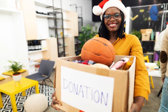 woman taking donations for holiday toy drive