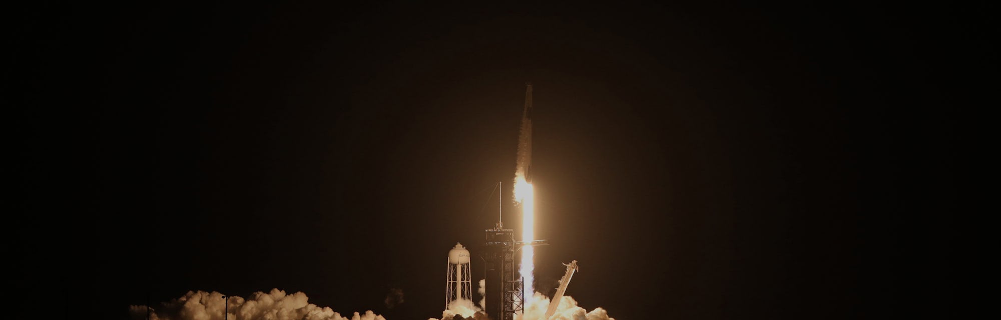 SpaceX rocket taking off from a launch pad.